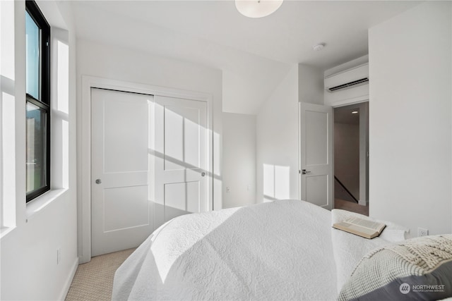 bedroom featuring multiple windows, a wall unit AC, light colored carpet, and a closet