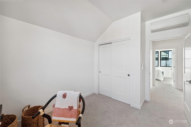 rec room featuring light carpet, lofted ceiling, and a wall mounted air conditioner