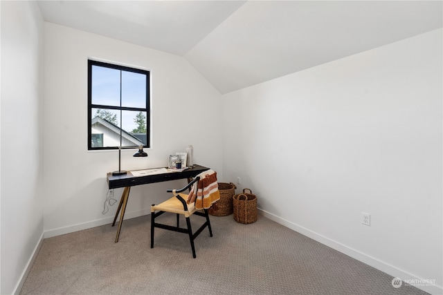 office space featuring light carpet and vaulted ceiling