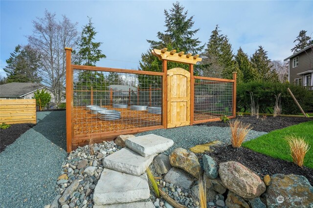 3917 Crosswinds Ct, Anacortes, WA 98221 - view of jungle gym featuring fence, a gate, and a vegetable garden