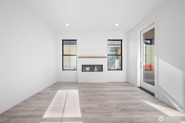 unfurnished living room with light wood-type flooring