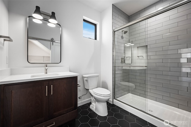 bathroom with toilet, vanity, tile patterned flooring, and an enclosed shower