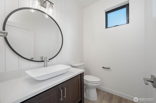 bathroom featuring hardwood / wood-style flooring, vanity, and toilet