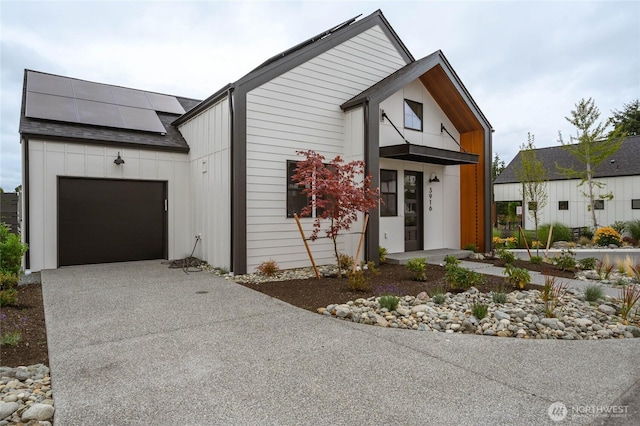 3917 Crosswinds Ct, Anacortes, WA 98221 - modern farmhouse with an attached garage, concrete driveway, and solar panels