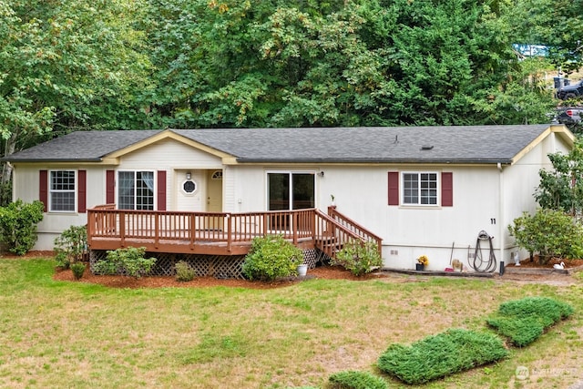 ranch-style house with a front lawn and a wooden deck