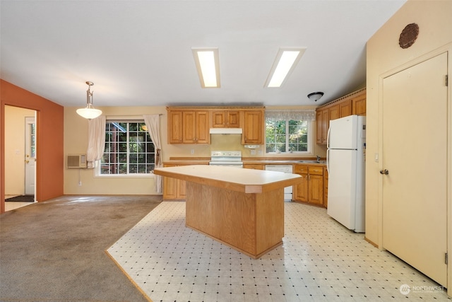 kitchen featuring a wall unit AC, a center island, white appliances, light colored carpet, and pendant lighting