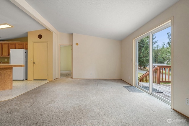 11 SE Fuchsia Ave, Shelton, WA 98584 - unfurnished living room featuring vaulted ceiling, light colored carpet, and baseboards