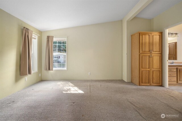 11 SE Fuchsia Ave, Shelton, WA 98584 - unfurnished bedroom with light carpet, a sink, ensuite bath, and vaulted ceiling