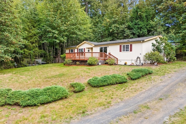 view of front of home featuring a deck and a front yard