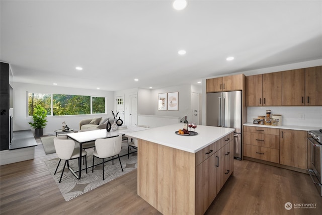 kitchen featuring a center island, wood-type flooring, and stainless steel appliances