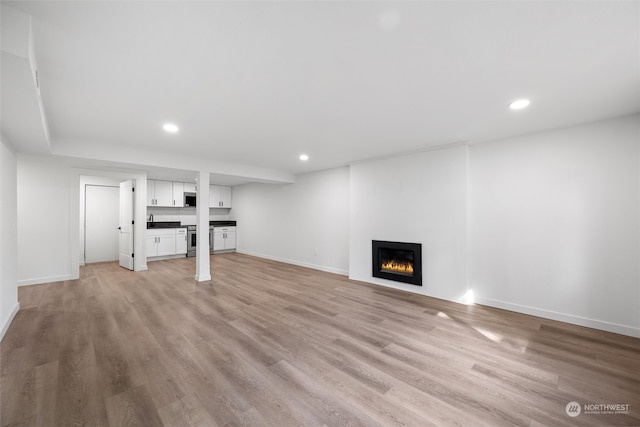 unfurnished living room with light hardwood / wood-style flooring