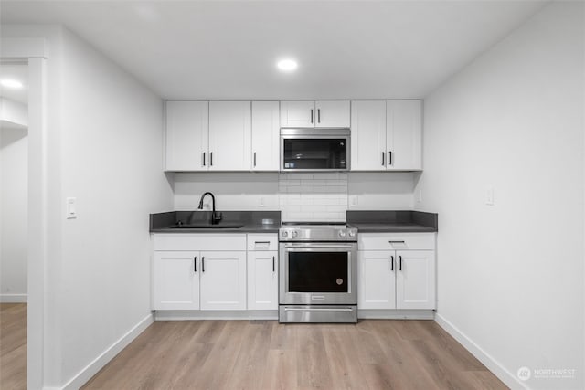 kitchen with white cabinets, stainless steel appliances, and sink