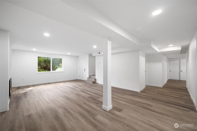 basement featuring dark hardwood / wood-style flooring