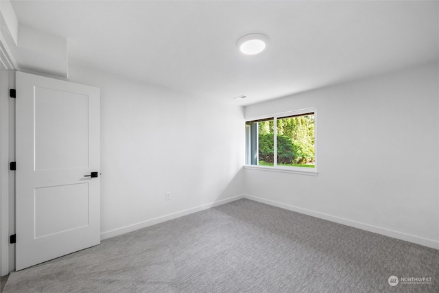 unfurnished room with light colored carpet