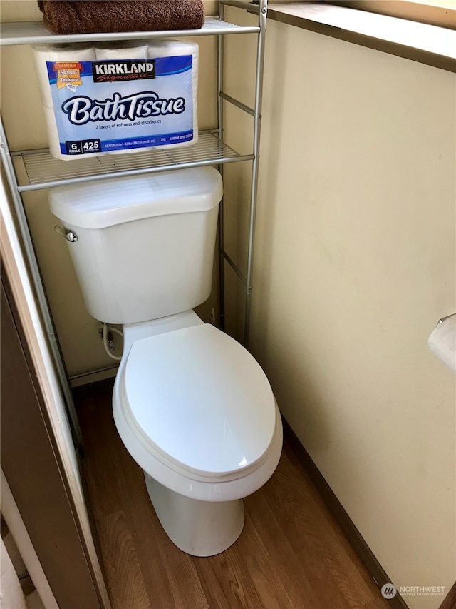 bathroom featuring wood-type flooring and toilet