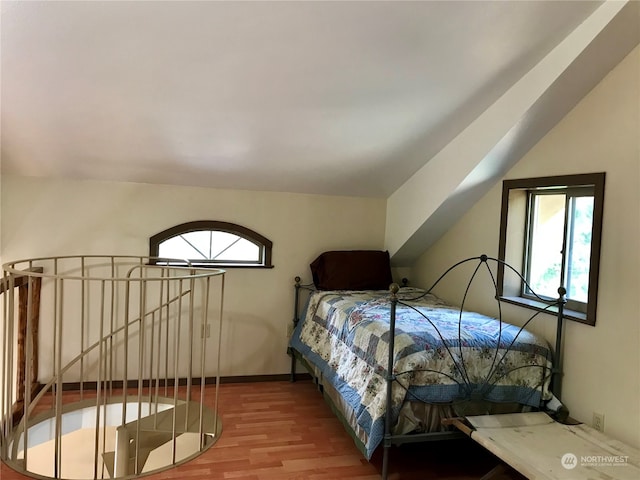 bedroom featuring wood-type flooring and lofted ceiling