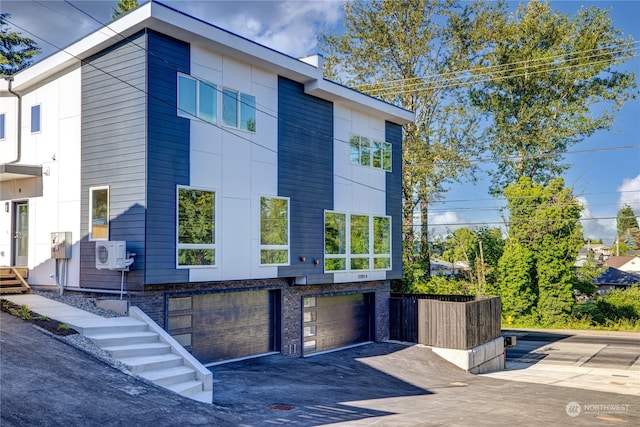 view of side of home with ac unit and a garage