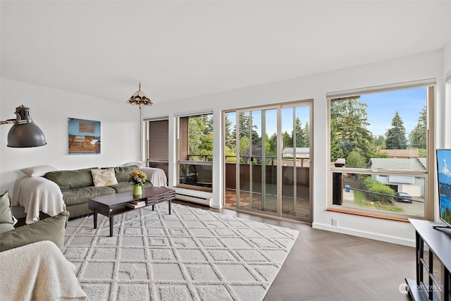 living room featuring parquet flooring and a wealth of natural light