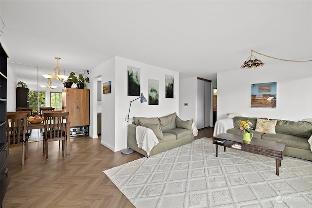 living room featuring a chandelier and light parquet floors