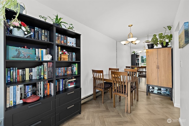 dining area with a baseboard radiator and light parquet flooring