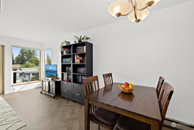 dining space with baseboard heating and dark parquet floors