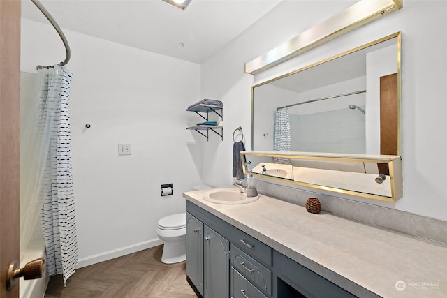 bathroom featuring parquet floors, vanity, and toilet