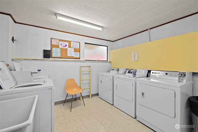 washroom with independent washer and dryer and crown molding