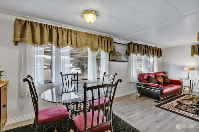 dining space with light hardwood / wood-style flooring