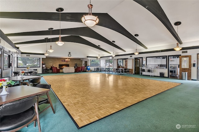 misc room featuring parquet flooring, brick wall, and vaulted ceiling with beams