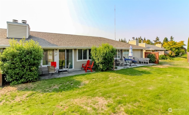 rear view of house featuring a lawn and a patio area