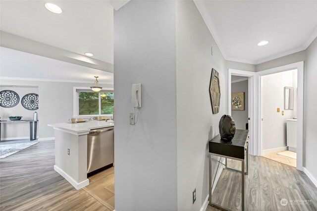 hall with crown molding and light wood-type flooring