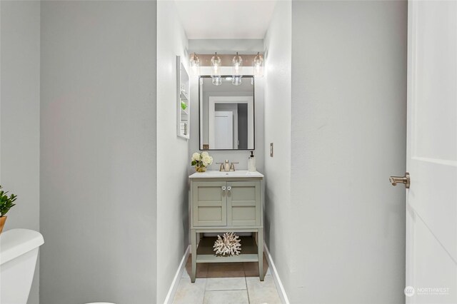 bathroom with vanity, tile patterned floors, and toilet