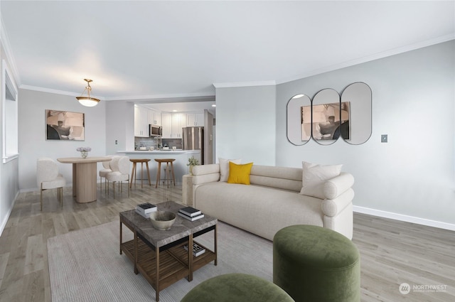 living room with crown molding and light hardwood / wood-style floors