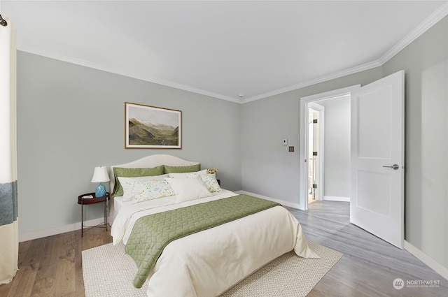 bedroom with wood-type flooring and crown molding