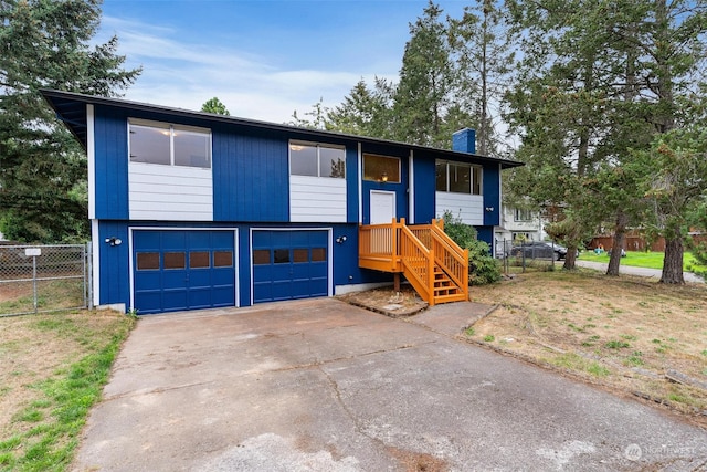 split foyer home featuring a garage and a front yard