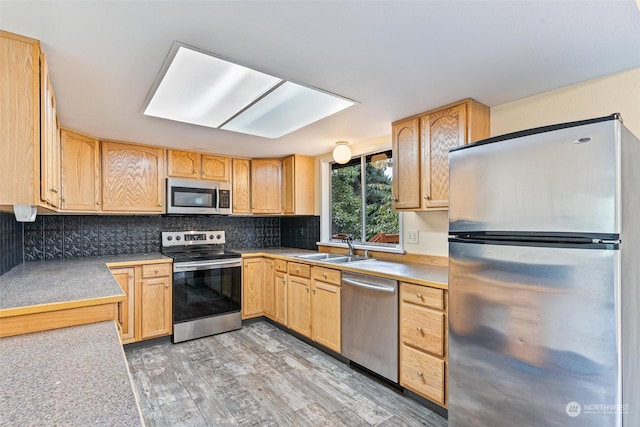 kitchen featuring light hardwood / wood-style flooring, light brown cabinetry, tasteful backsplash, stainless steel appliances, and sink