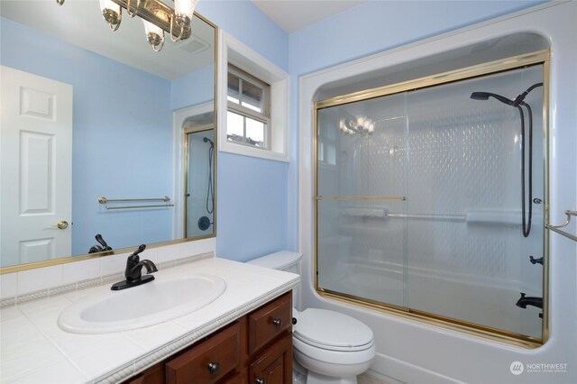 bathroom featuring vanity, toilet, visible vents, and combined bath / shower with glass door