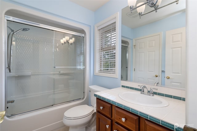 full bathroom featuring toilet, shower / bath combination with glass door, a chandelier, and vanity