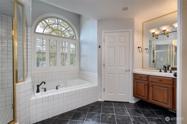 bathroom featuring tile patterned flooring, a garden tub, vanity, and tiled shower