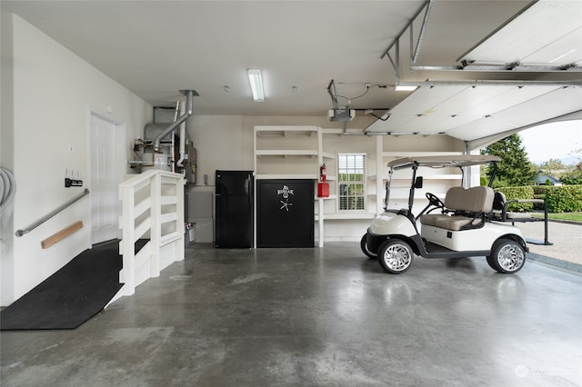 garage with black fridge and a garage door opener