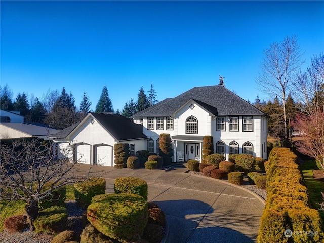 view of front of home with a garage and concrete driveway