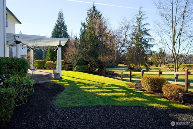 view of yard featuring fence and a pergola