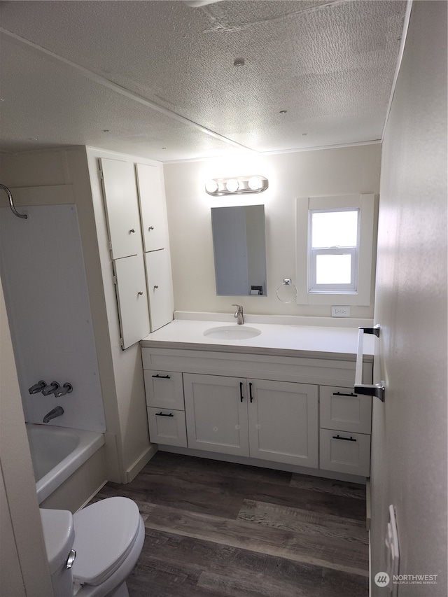 full bathroom featuring wood-type flooring, toilet, shower / bath combination, and vanity