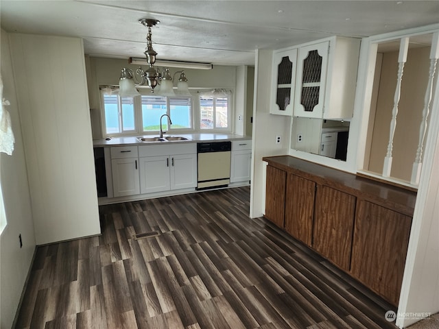 kitchen featuring dark hardwood / wood-style flooring, dishwasher, a notable chandelier, sink, and white cabinetry