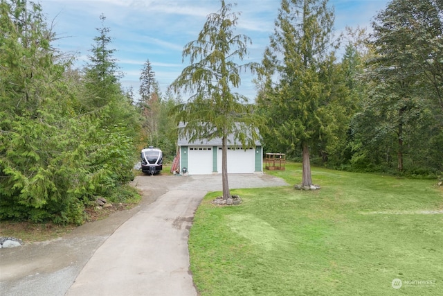 view of front of house featuring a garage and a front lawn