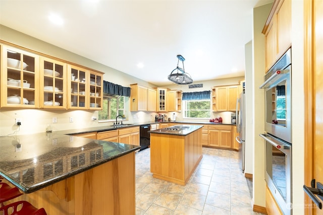 kitchen with pendant lighting, plenty of natural light, kitchen peninsula, and sink