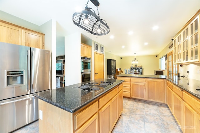 kitchen with decorative light fixtures, kitchen peninsula, a center island, appliances with stainless steel finishes, and light brown cabinets