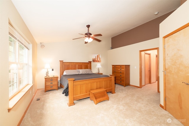 bedroom with light carpet, vaulted ceiling, and ceiling fan