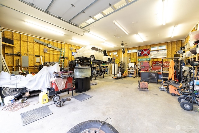 garage featuring wooden walls and a workshop area