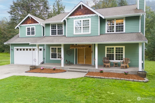 view of front of home with a porch, a garage, and a front yard